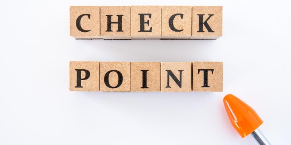 「CHECK POINT」と書かれたブロックとオレンジのペン先が並んだ白背景の画像