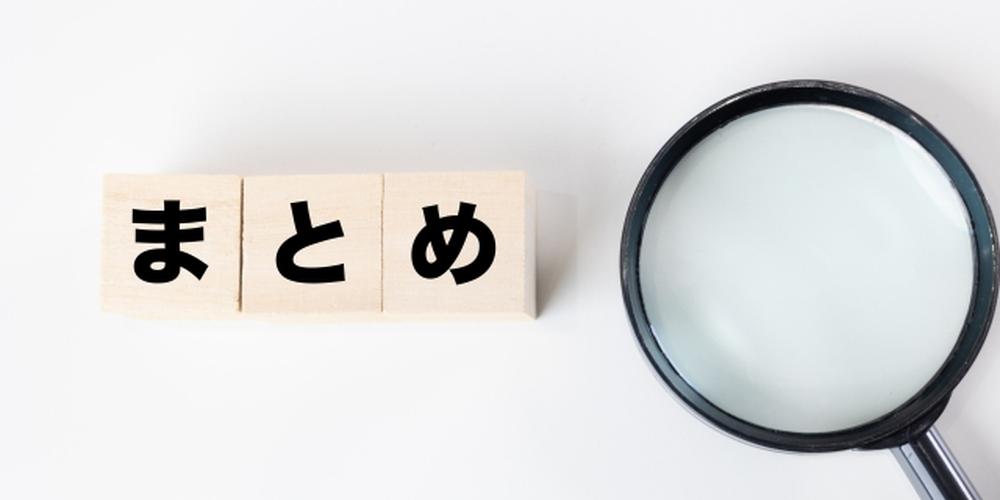 「“まとめ”の文字が書かれたブロックと、右に置かれた虫眼鏡」