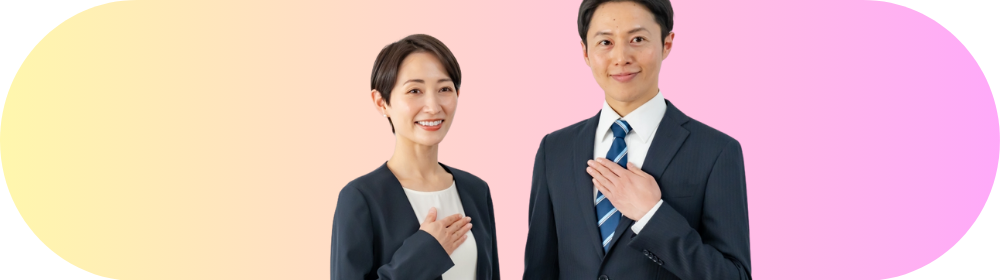 胸に手を当てて微笑むスーツ姿の男女スタッフが、淡いイエローからピンクへグラデーションした背景の中央に立つイメージ